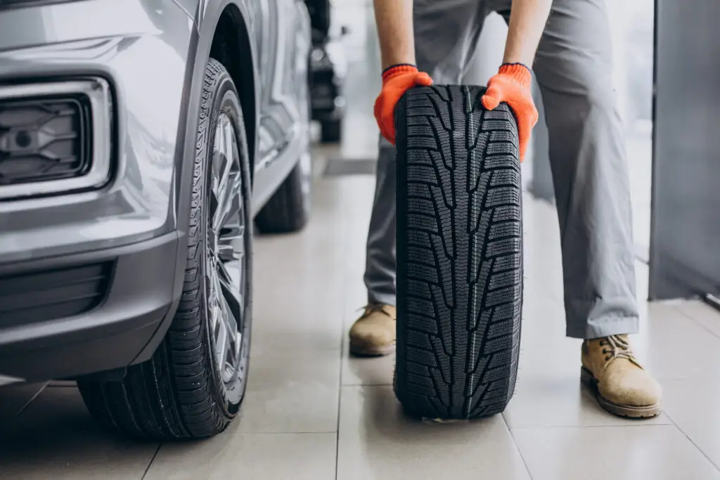 mechanic changing tires in a car service
